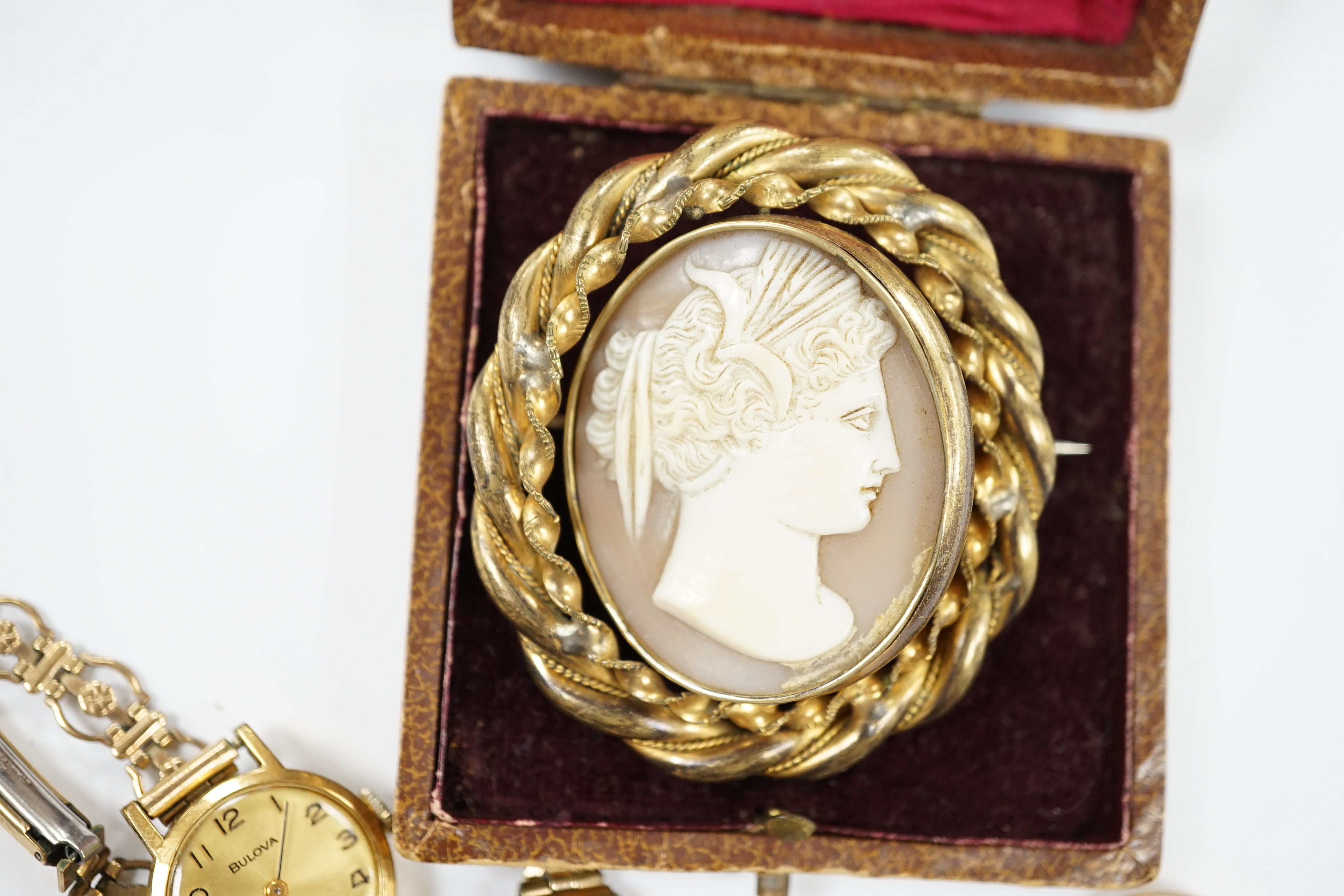 A Victorian 15ct gold and four (ex 5) stone garnet set half hoop ring, an 18ct gold ring, two lady's wrist watches including 9ct gold cased, a 9ct gold cross pendant and a gilt metal and cameo shell set brooch.